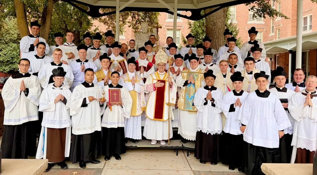 CMRI bishop, priests, and seminarians gathered outdoors